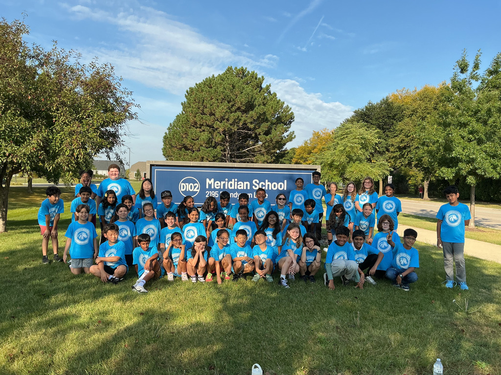 Class photo in front of Meridian sign.