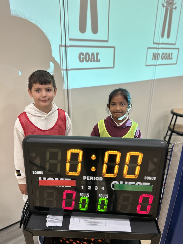 Students standing by the score board.