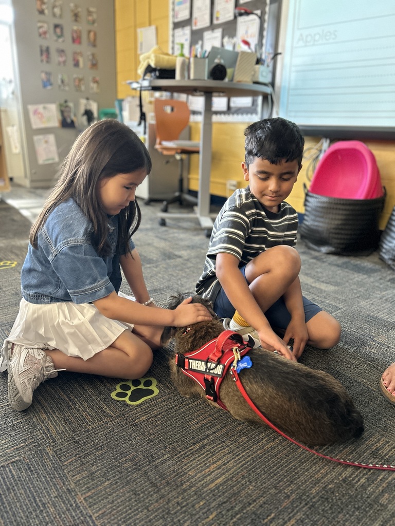 Students petting a dog.