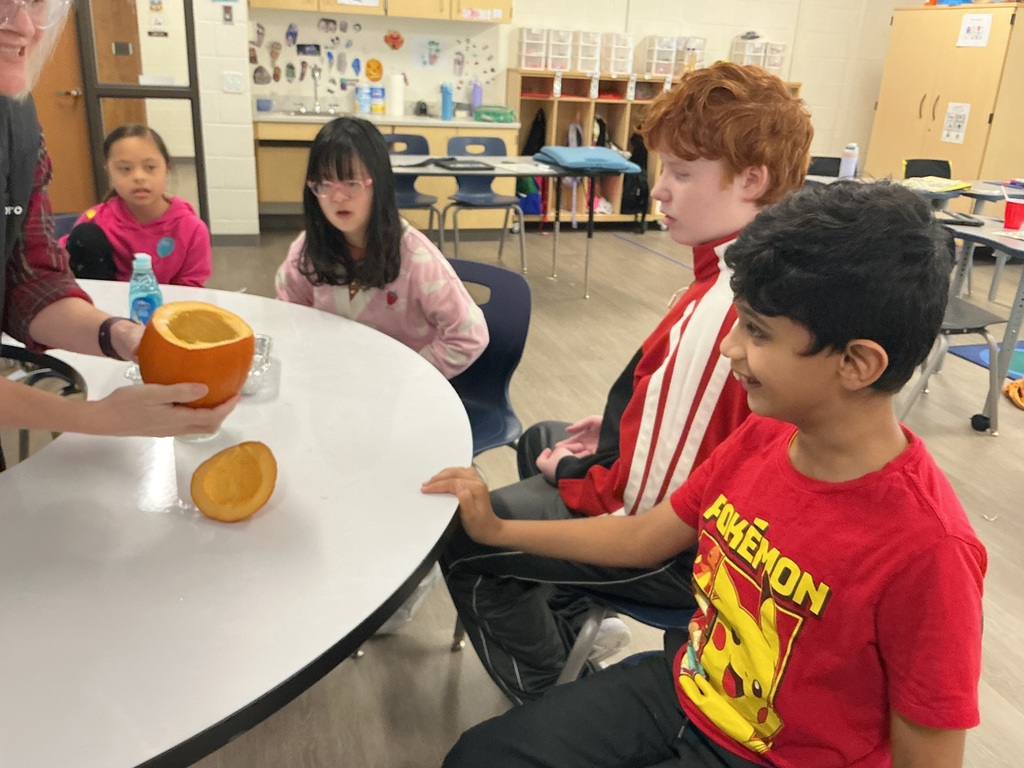 Students doing an experiment with a pumpkin.
