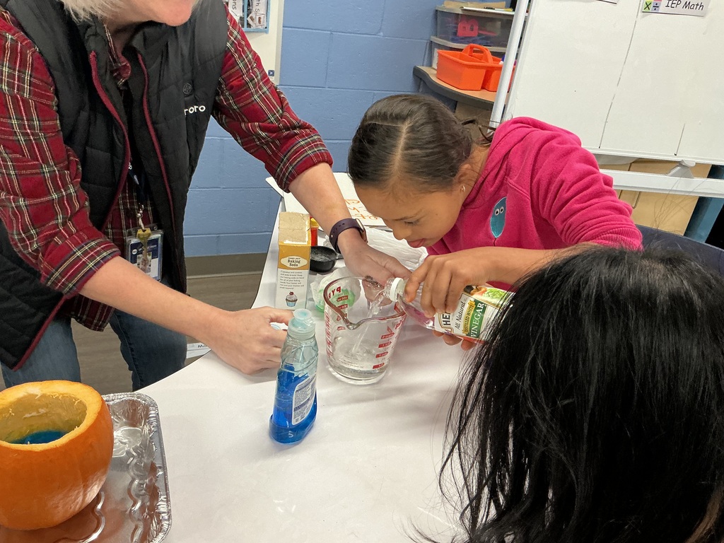 Student measuring a liquid at a table.