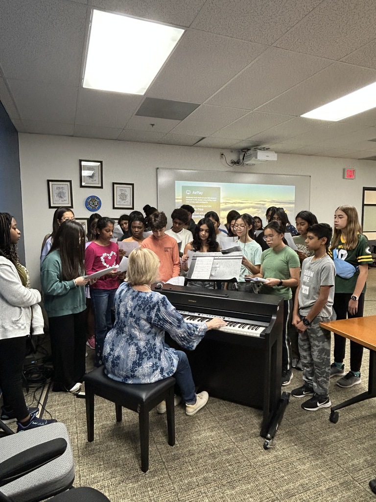 Students singing in the Board room.