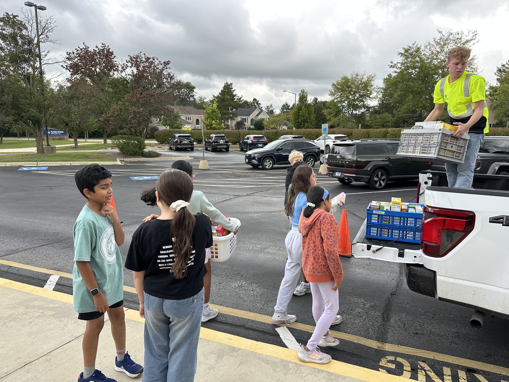 Students loading up a truck of cereal boxes.
