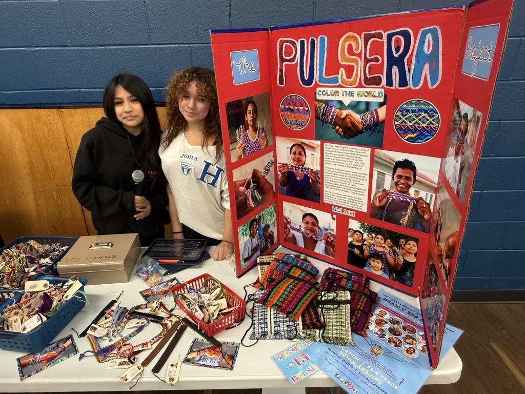 Two students standing in front of a poster.