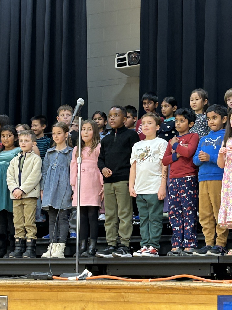 students on stage singing.
