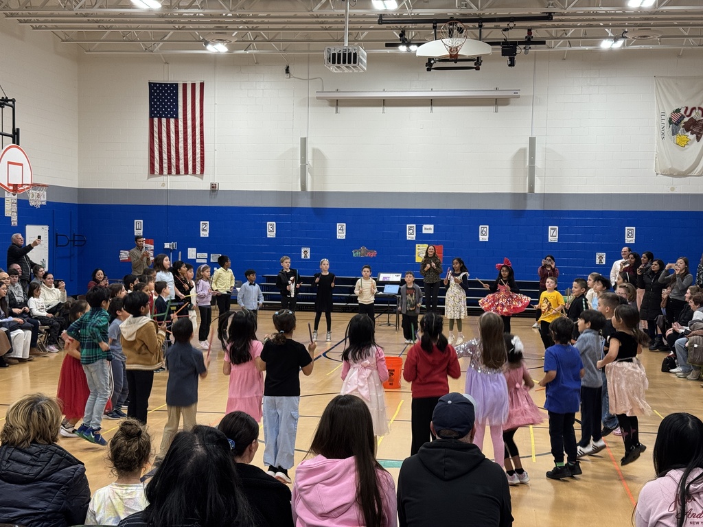 Students dancing in a circle and dancing.