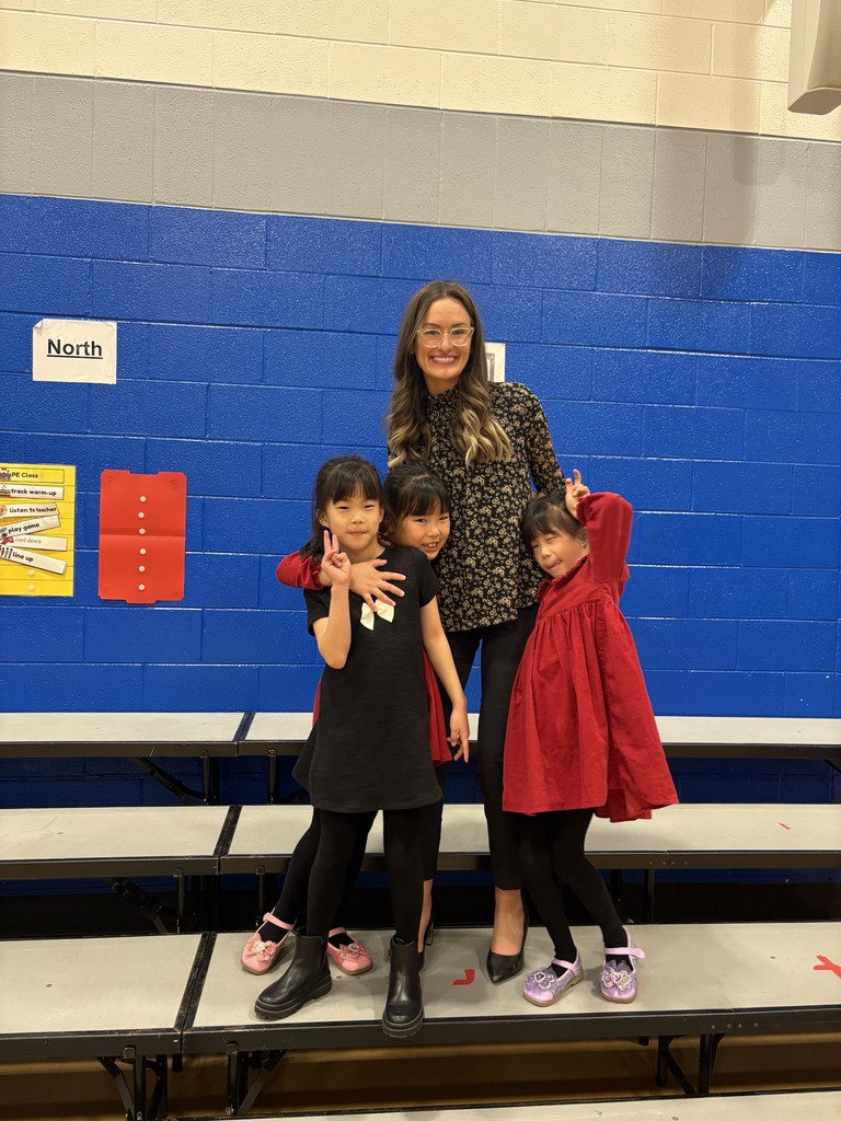 Teacher standing with 3 girls.