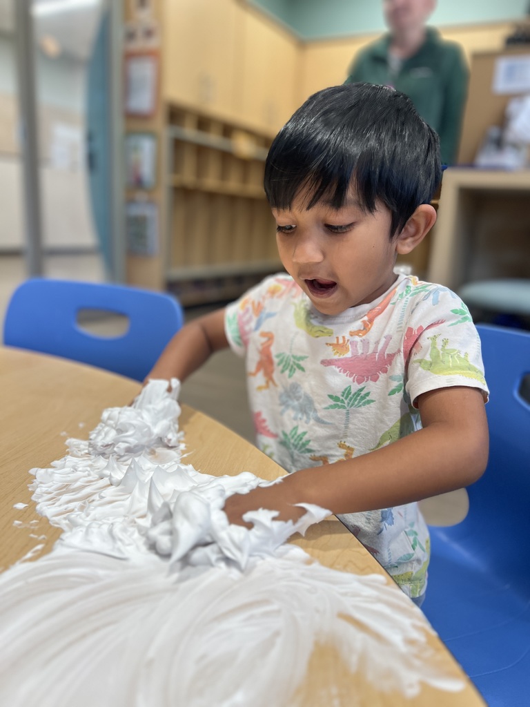 Student playing with shaving cream.