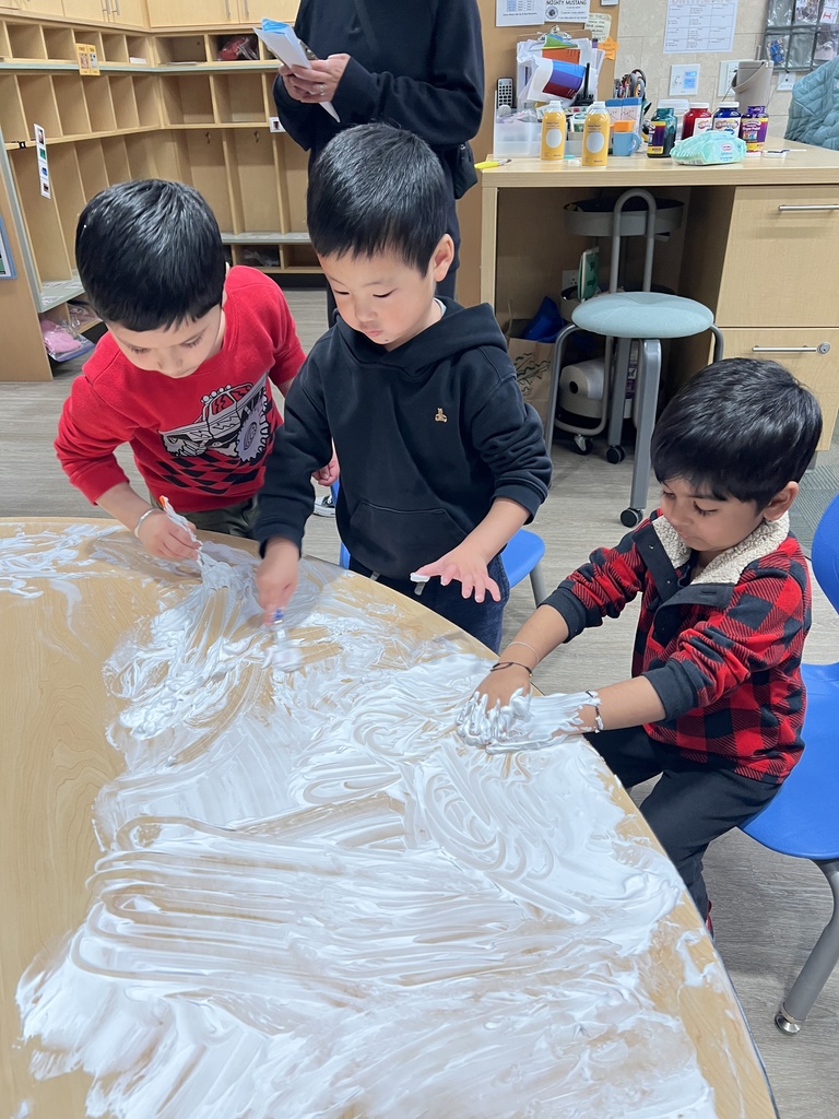 Students sitting at their tables with shaving cream.