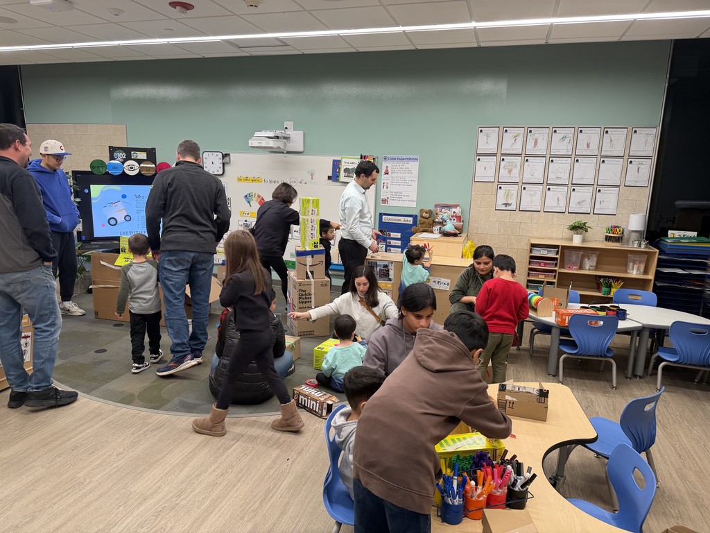 Parents with their child in the classroom.