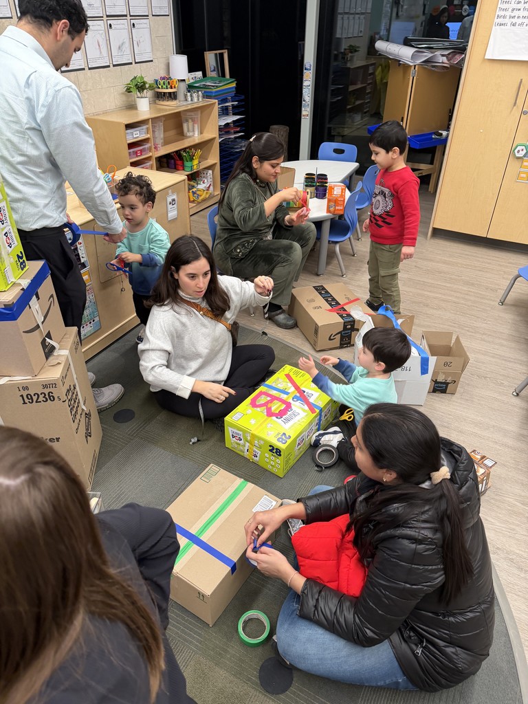 Parents playing with their kids on the floor.