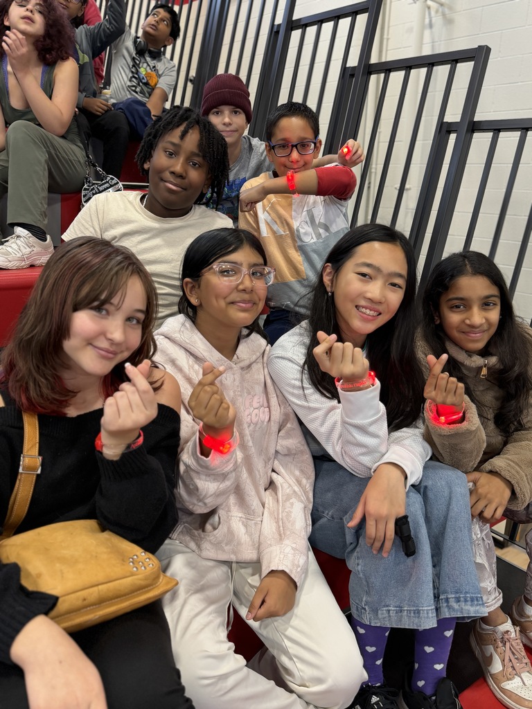 Students with their light up bracelets in the bleachers.