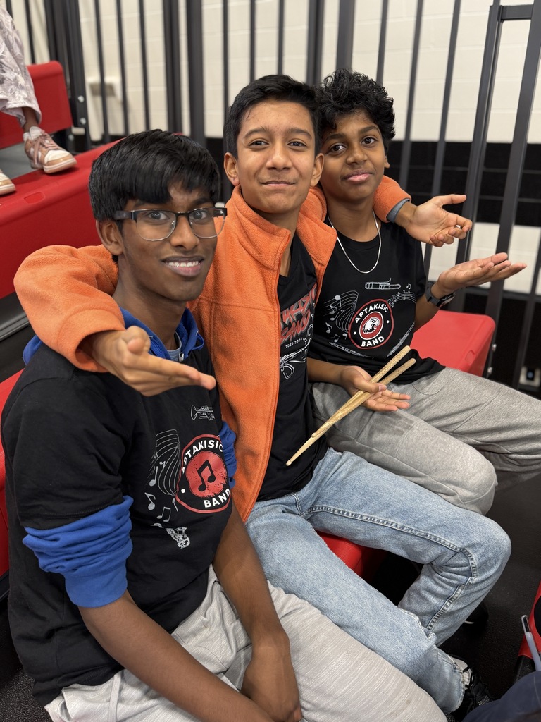 Boys sitting together in the bleachers.