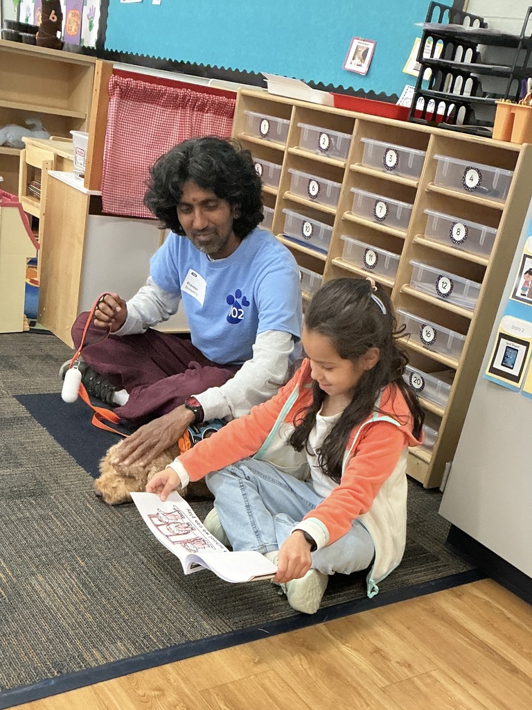 Girl reading to a therapy dog.