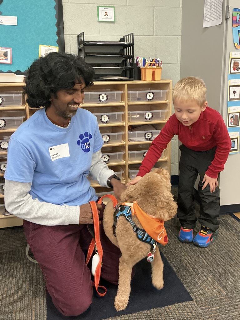 Boy petting a therapy dog.