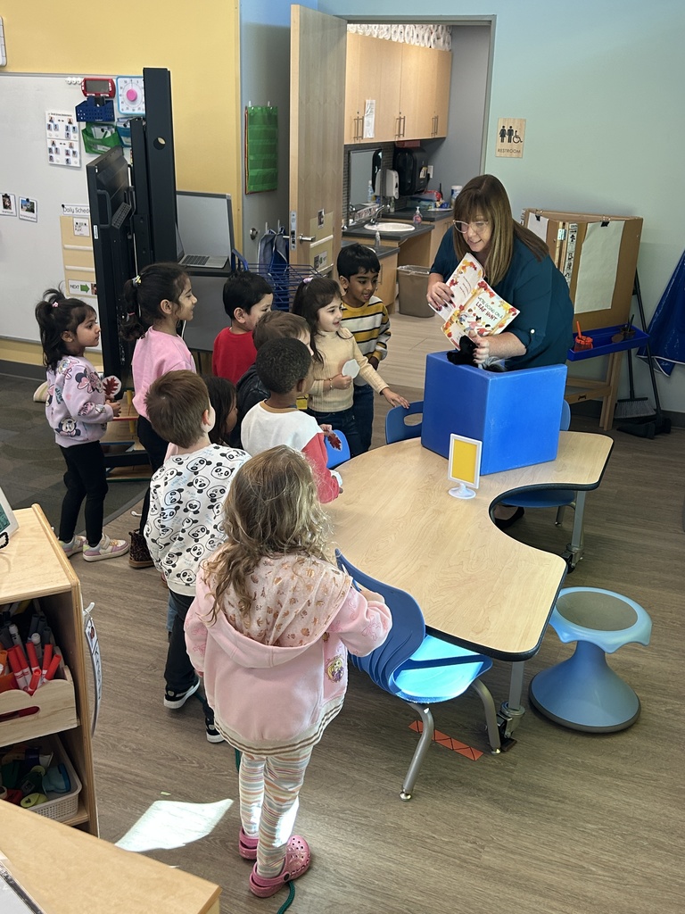 Teacher reading a book to the class.