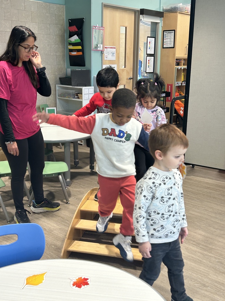 Students hopping over obstacles.