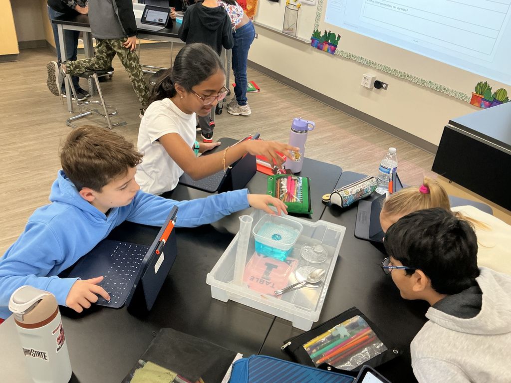 Students working at their desks doing an experiment.