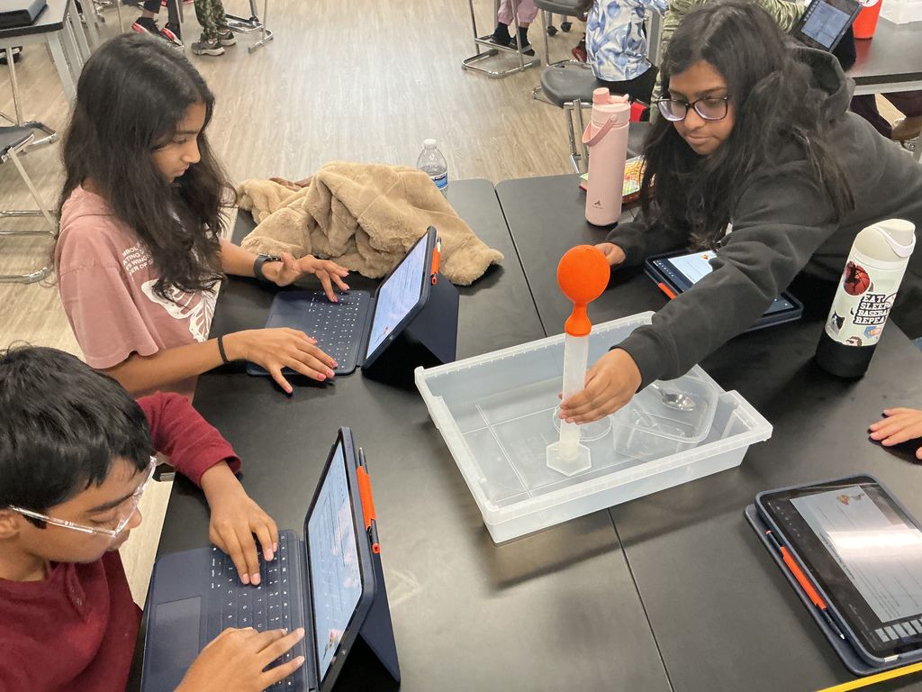 Students working at their desks with ipads.