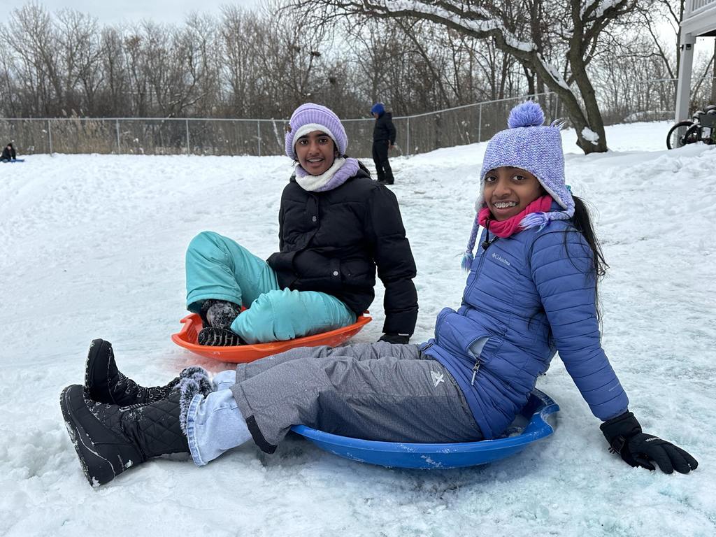 Students getting ready to sled down a hill.