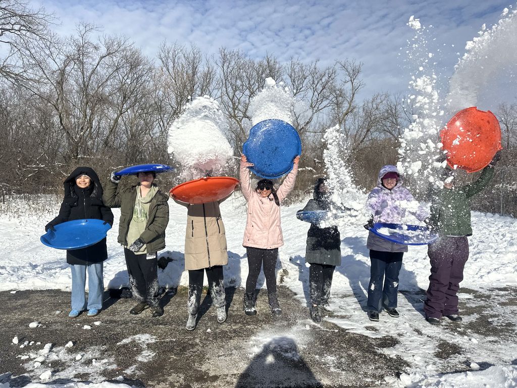 Students throwing snow in the air.
