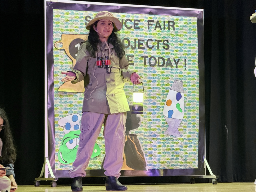 Student on stage performing in a play.