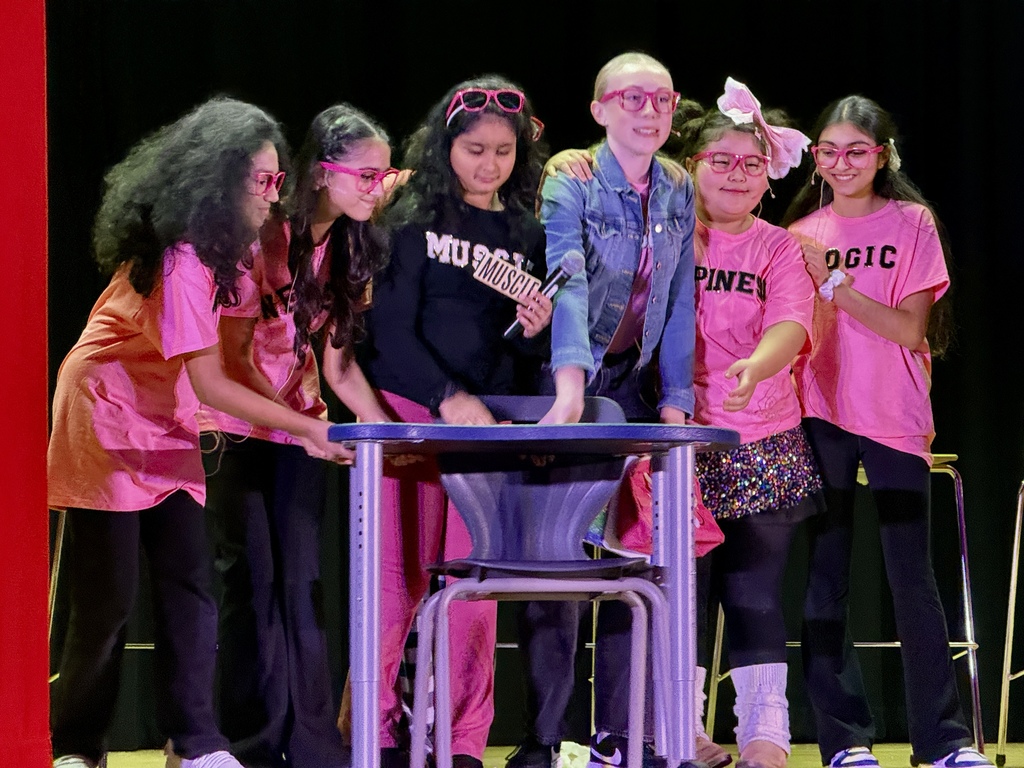 Students performing on stage for a play.