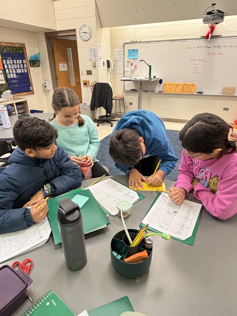 Students working at their table in a group.
