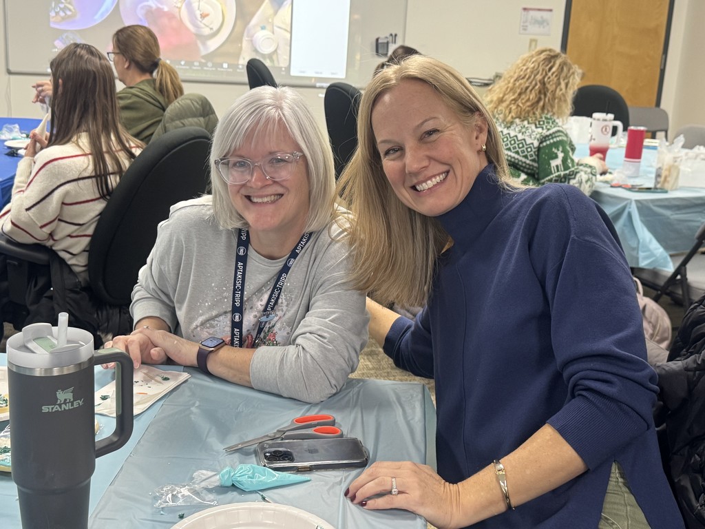 Teachers sitting together getting ready to decorate their cookies.