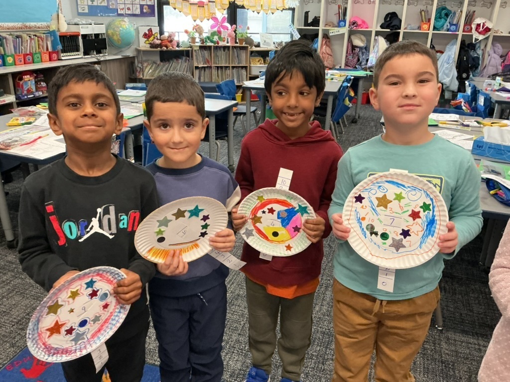 Students holding up their crafts.