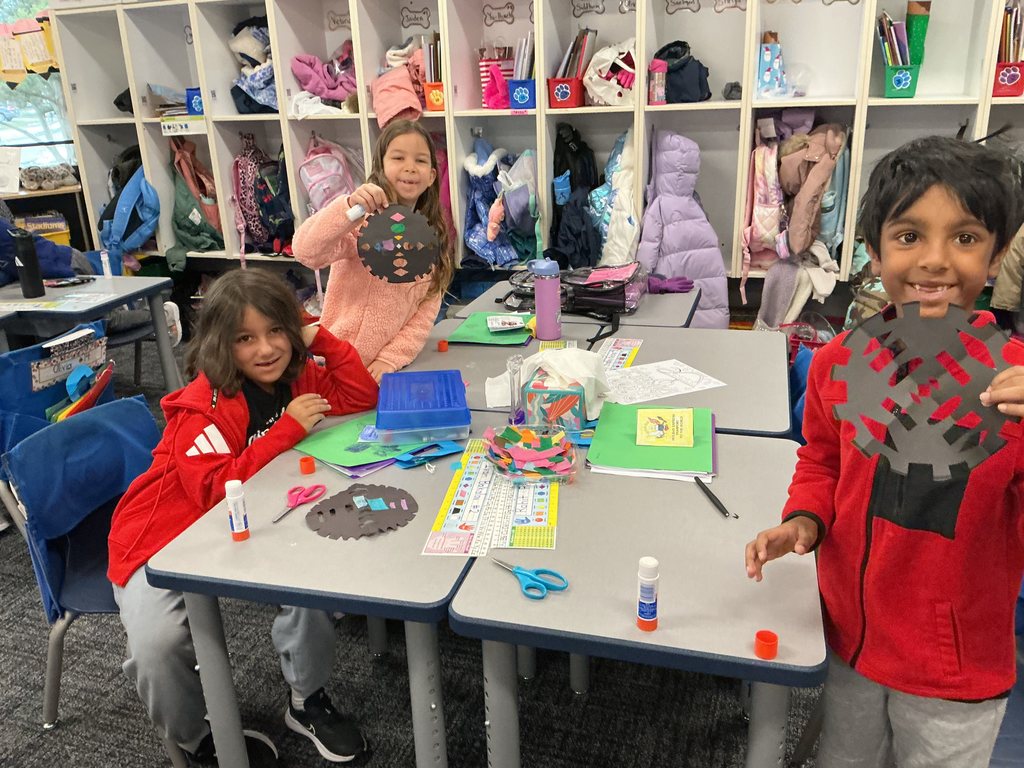 Students holding up their craft.