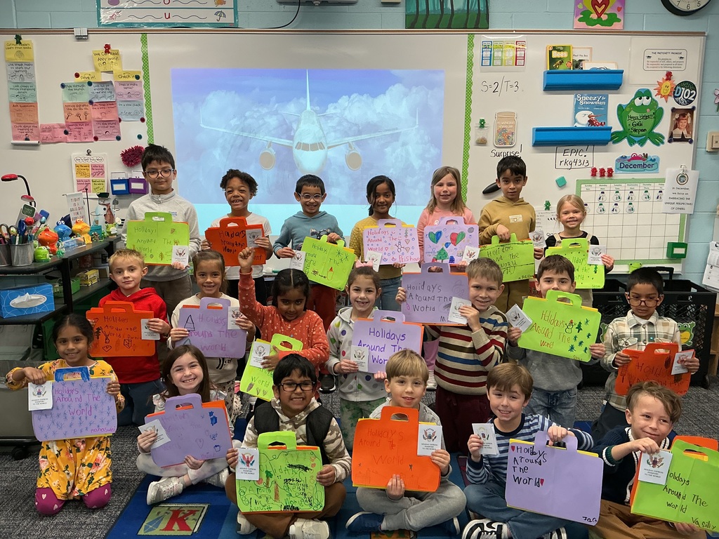 Students holding up a craft.