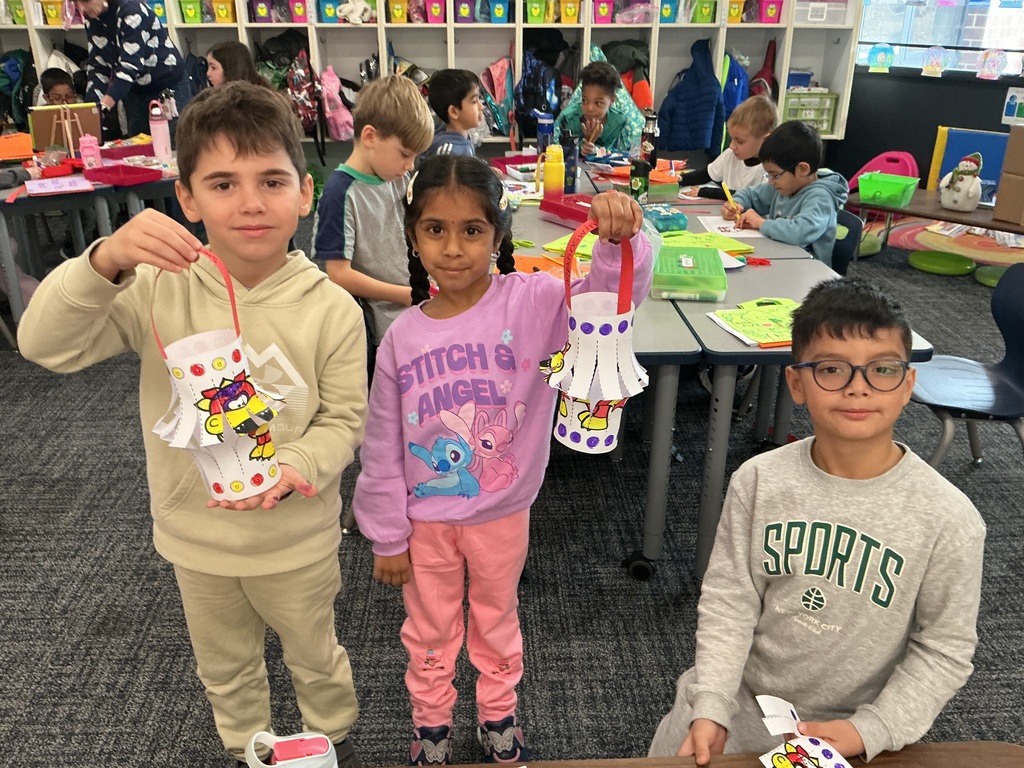 Students holding up their creations.