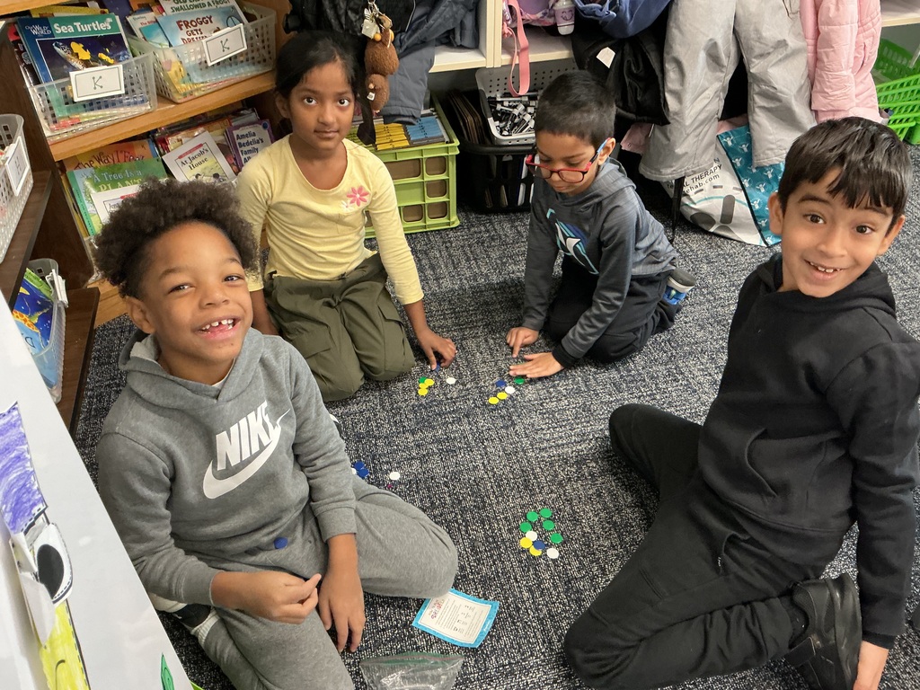 Students working on the floor with a craft.