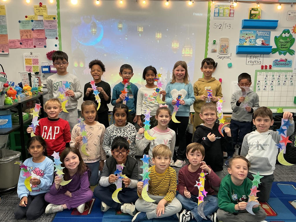 A class holding up their craft.