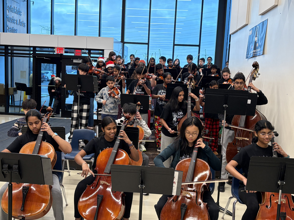 Orchestra students playing in the entrance of AJHS.