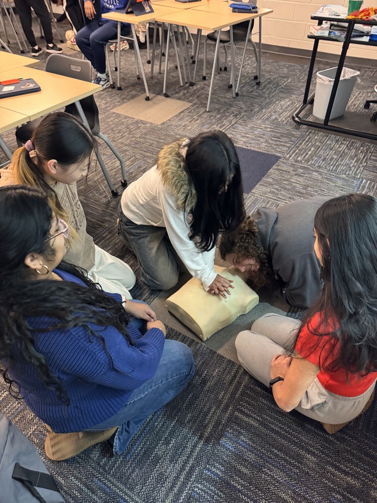 Students doing compression on a dummy.