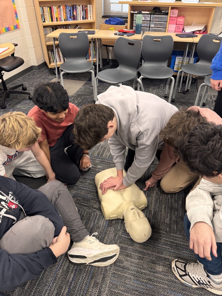 Students doing compression on a dummy.