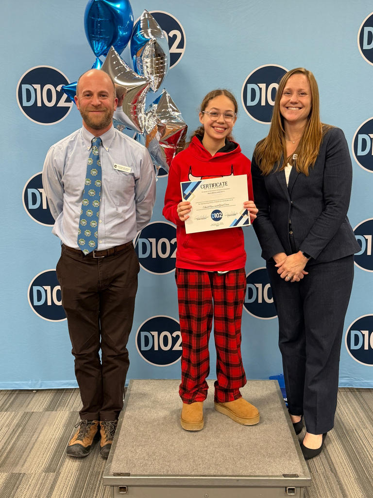 Student standing with her certificate.
