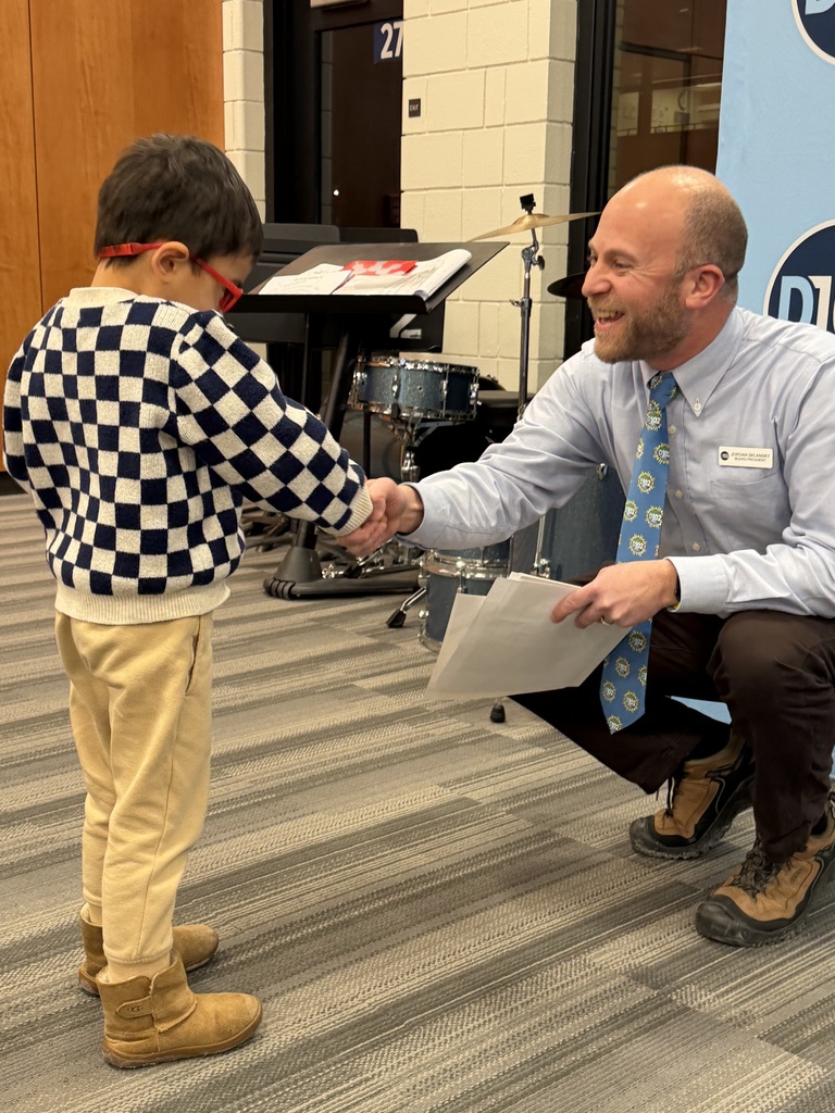 Mr. Sklansky shakes hands with little boy.
