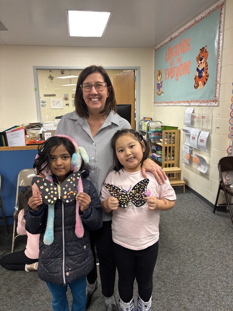 Teacher with 2 kids and a craft.