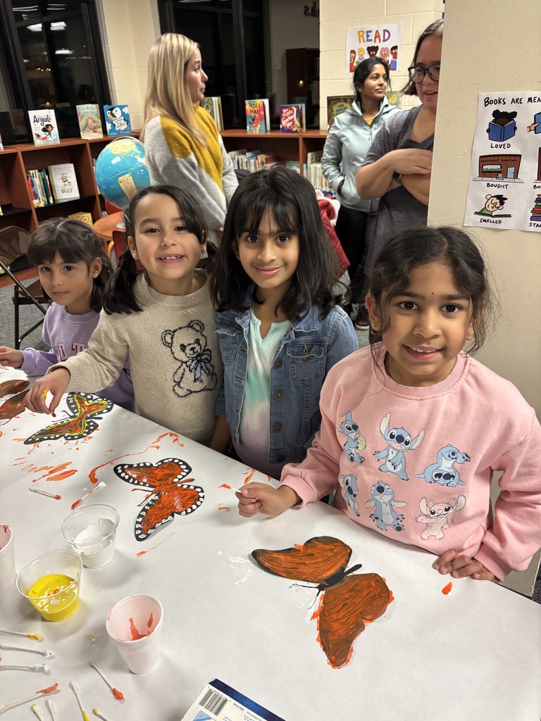 Girls making a butterfly craft. 