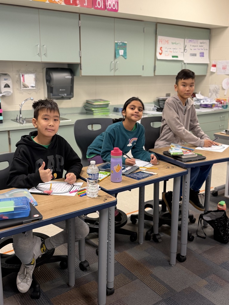 3 students working at their desks. 