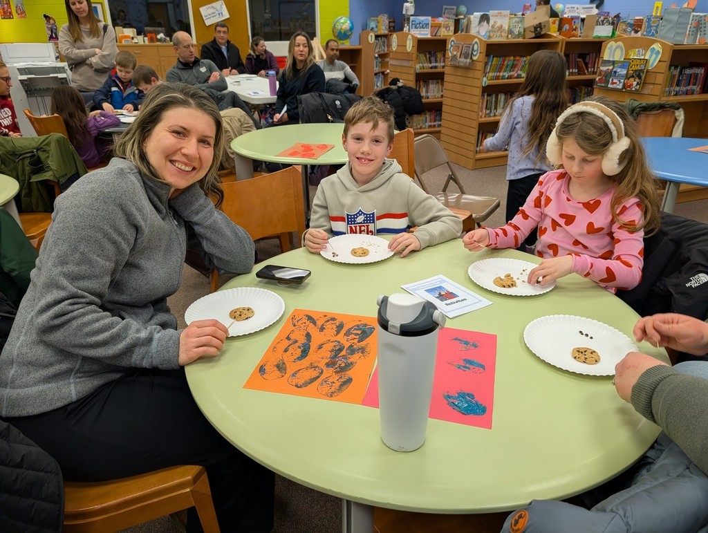 Family sitting together at a table ready to create.