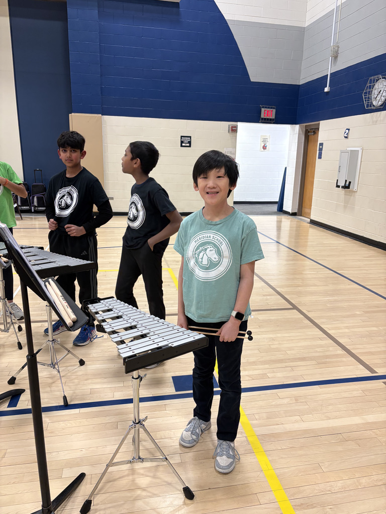 One boy smiling and looking at the camera. 