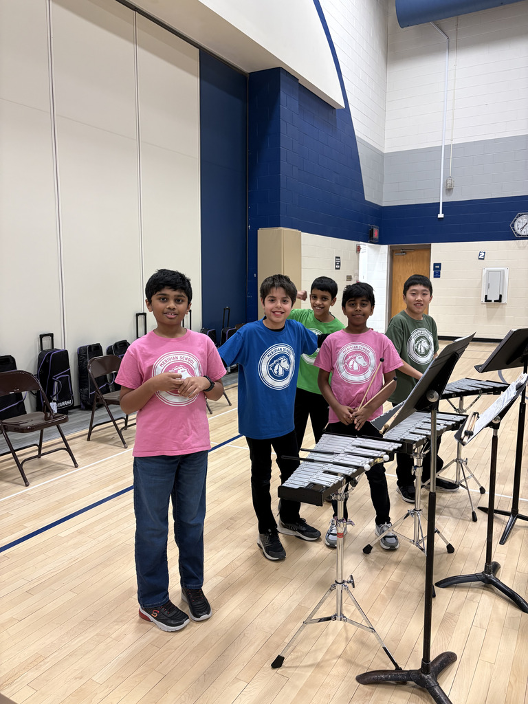 A group of boys standing with their instruments. 