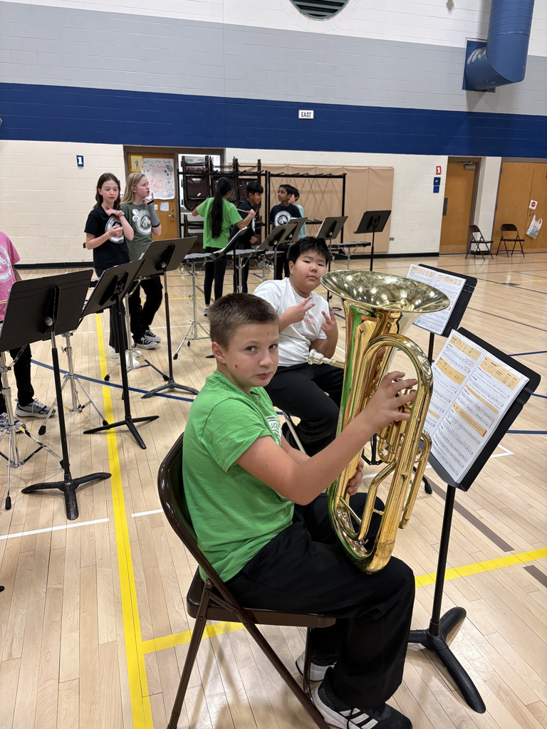 Students holding their instruments ready for the concert. 