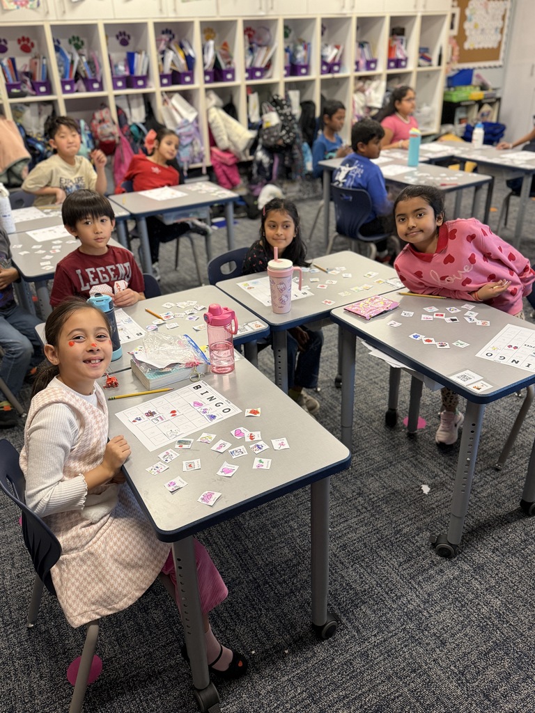Students playing Valentine bingo at their desks.