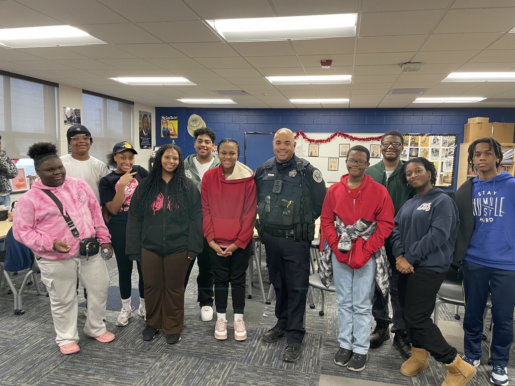 Students standing together with Officer Baker for Black History Month