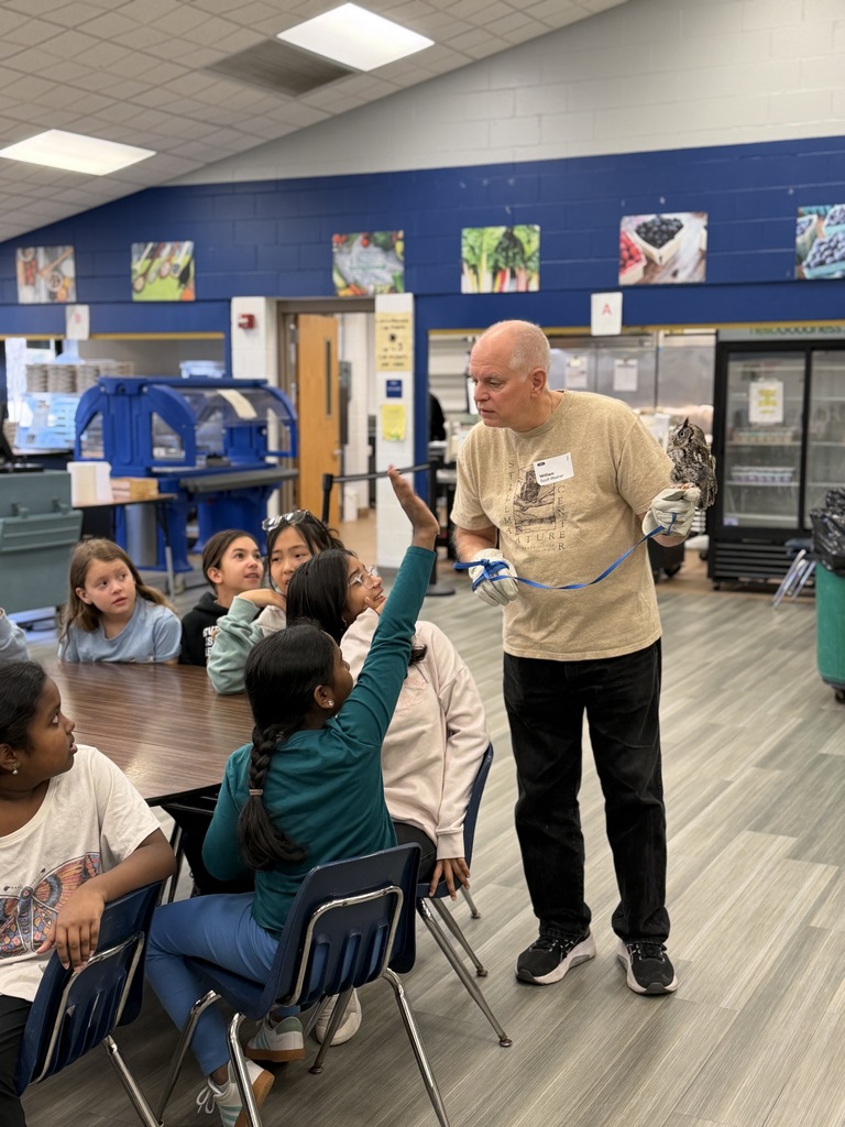 Owl handler answering questions while holding an owl. 